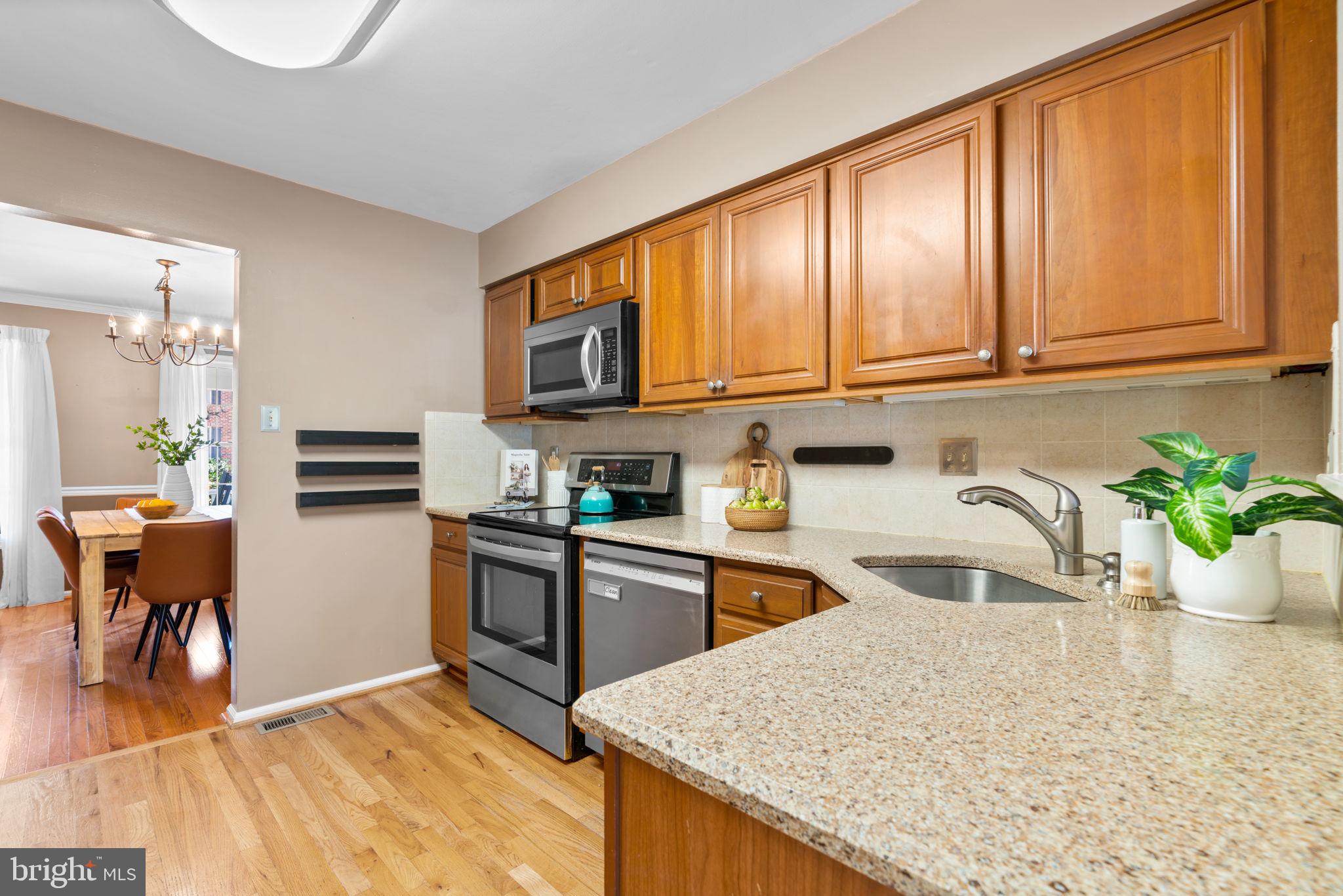 311 Canterfield Road Annapolis, MD 21403 - Photo 11 of 49 a kitchen with stainless steel appliances granite countertop a refrigerator a stove top oven a sink dishwasher and white cabinets with wooden floor