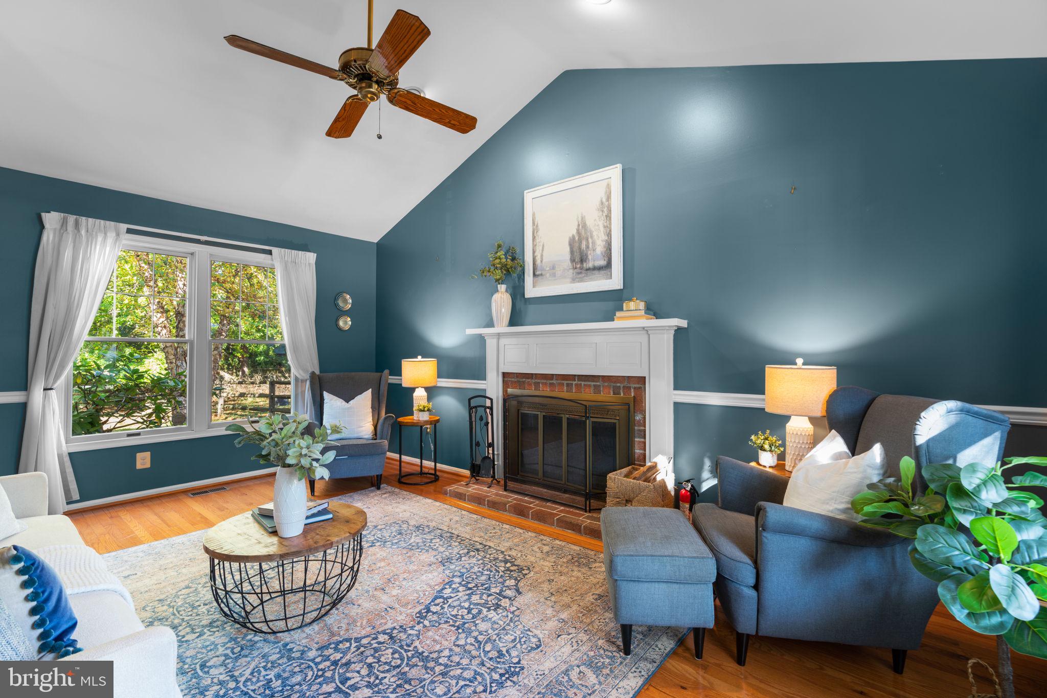 311 Canterfield Road Annapolis, MD 21403 - Photo 2 of 49 a living room with furniture a fireplace and a potted plant
