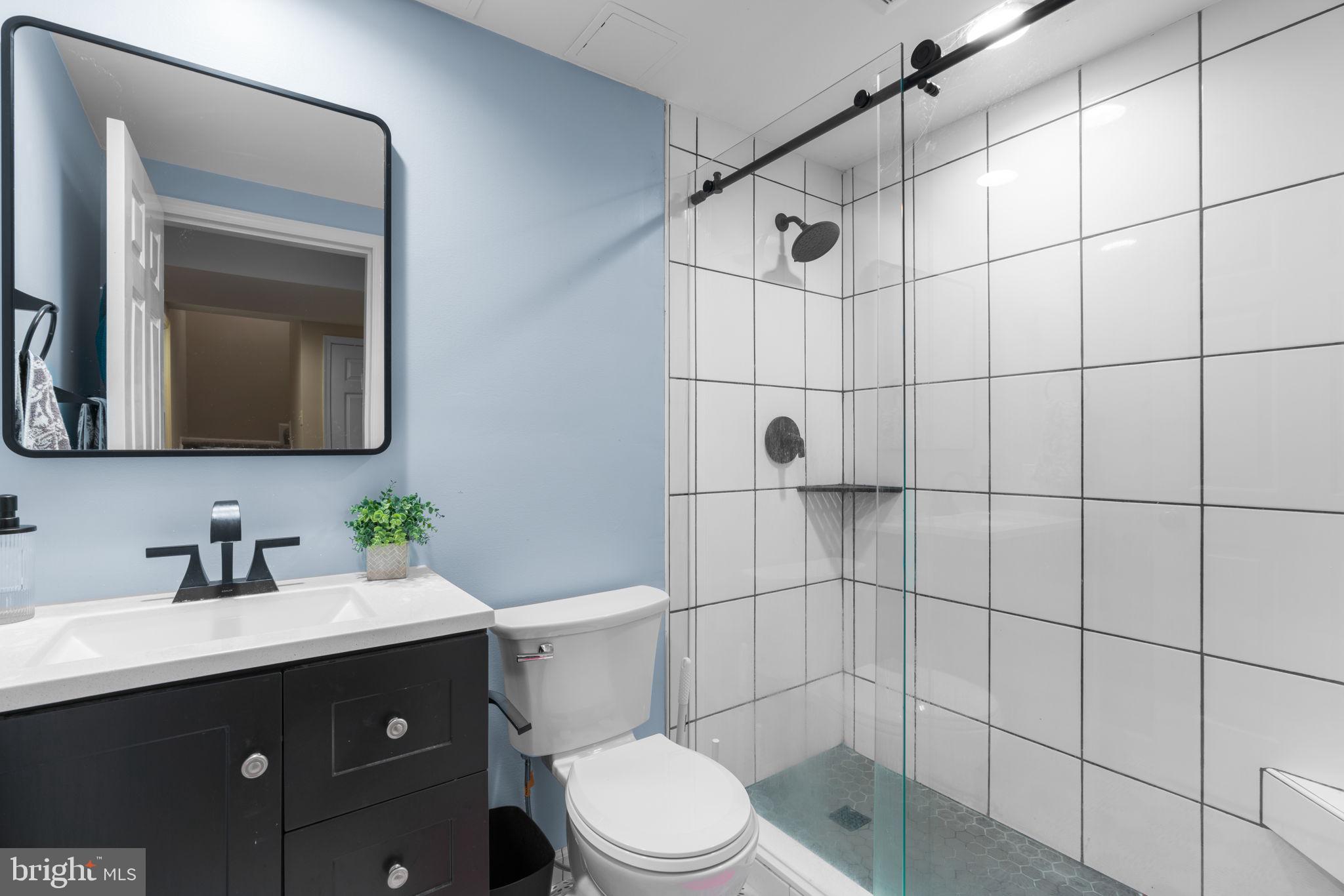 311 Canterfield Road Annapolis, MD 21403 - Photo 33 of 49 a bathroom with a toilet sink vanity and mirror