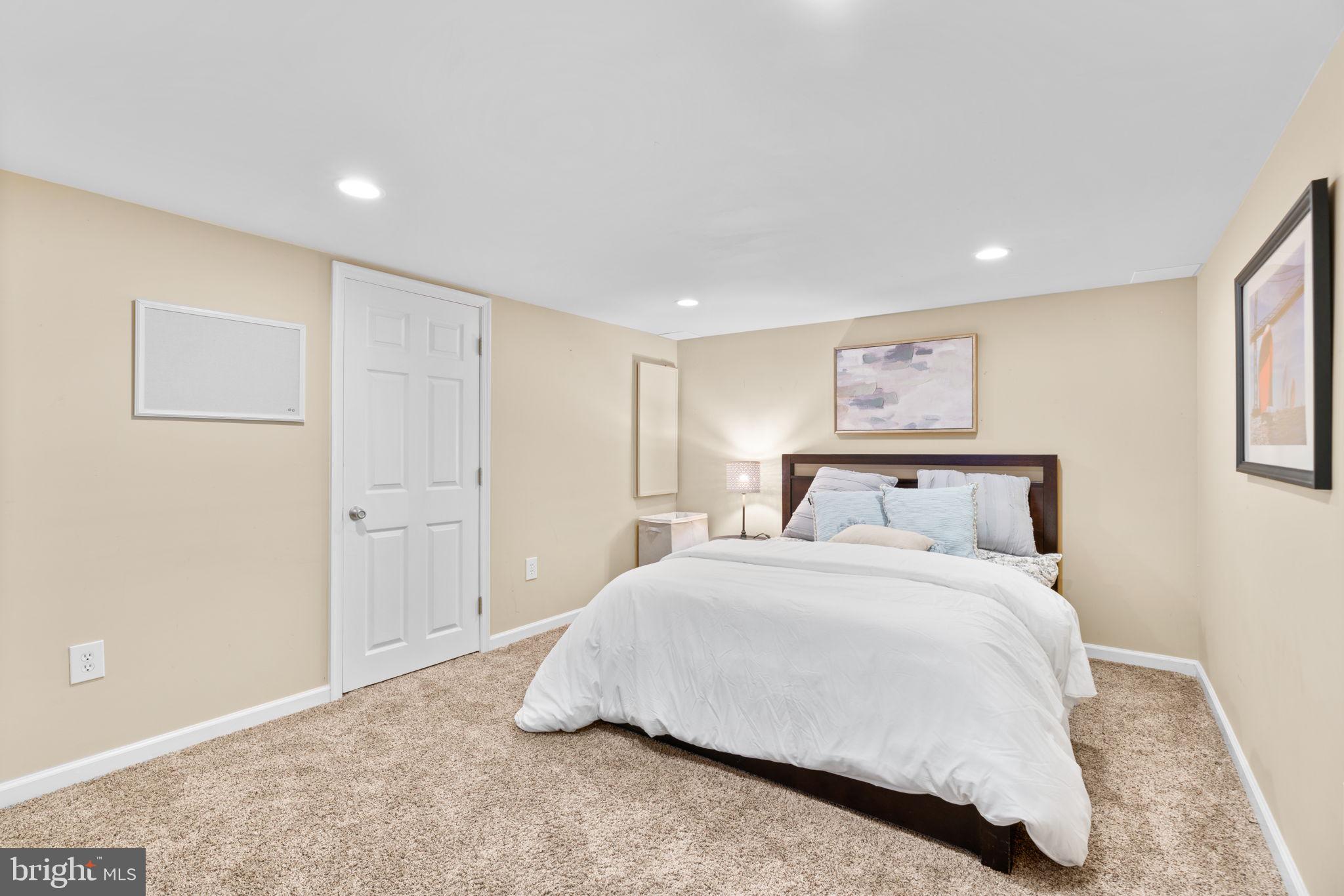 311 Canterfield Road Annapolis, MD 21403 - Photo 35 of 49 a spacious bedroom with a bed and a painting
