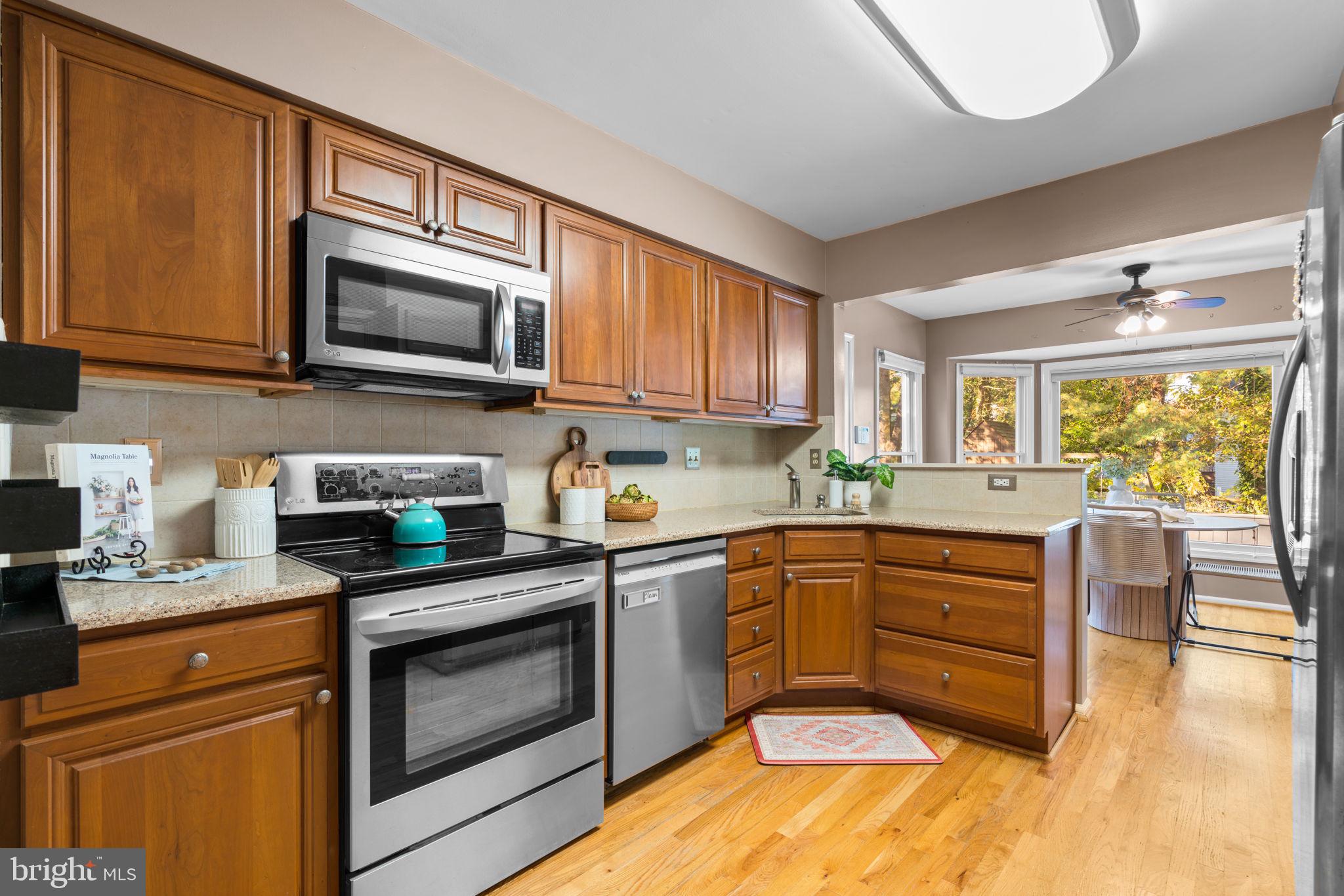 311 Canterfield Road Annapolis, MD 21403 - Photo 8 of 49 a kitchen with stainless steel appliances granite countertop a stove top oven a sink dishwasher and white cabinets
