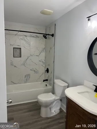 a bathroom with a toilet a sink and a shower