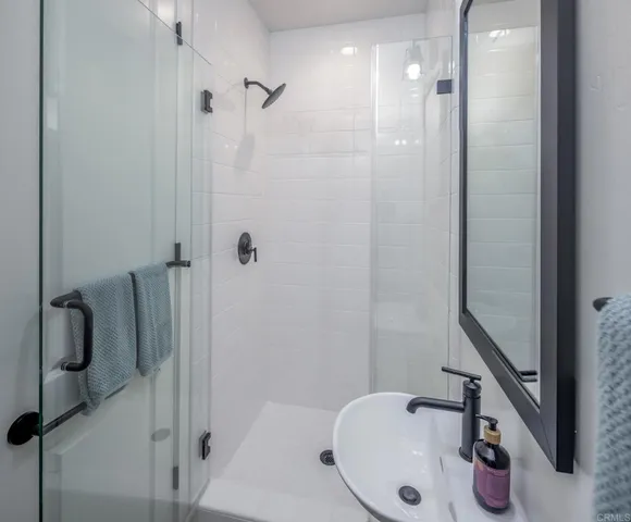 a bathroom with a sink and shower