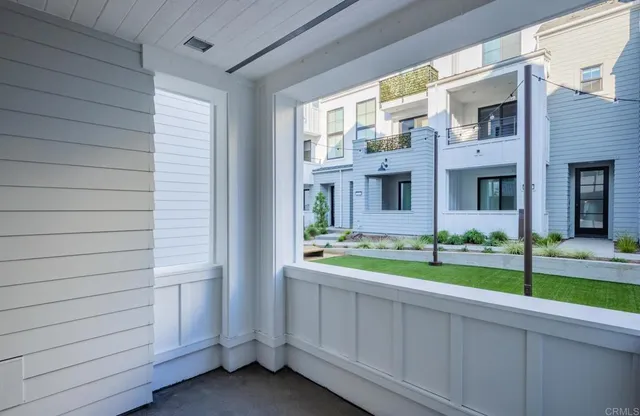 a view of a house with backyard and porch