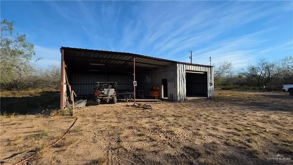 a view of a fire pit with large trees
