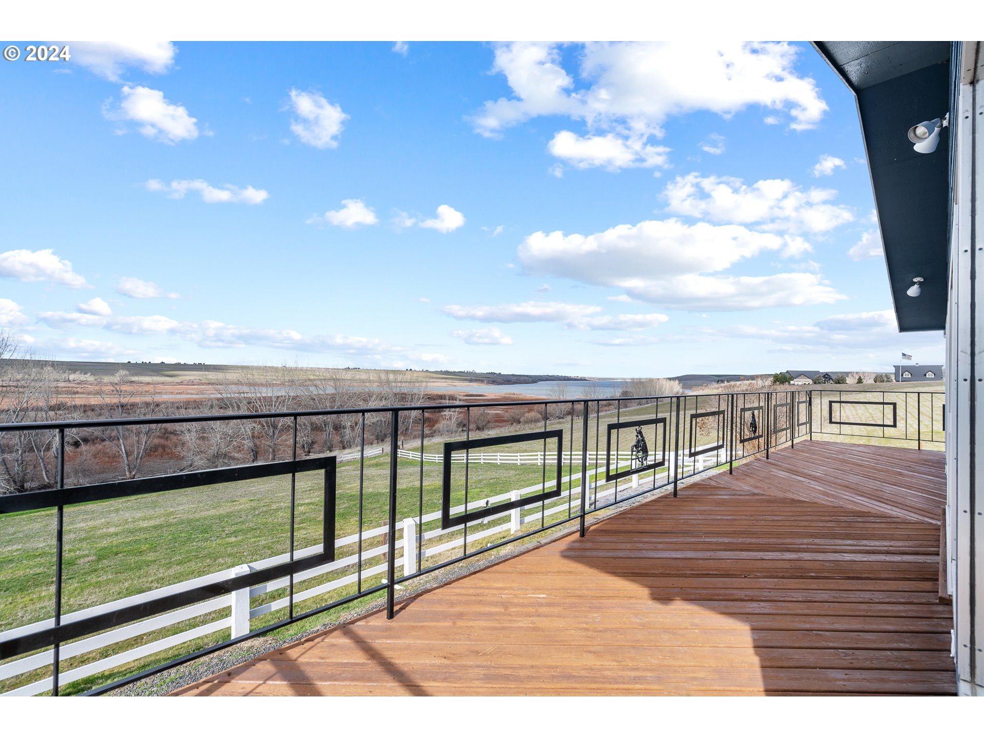 69748 Shaw Road Pendleton, OR 97801 - Photo 17 of 48 a view of balcony with floor to ceiling windows with wooden floor