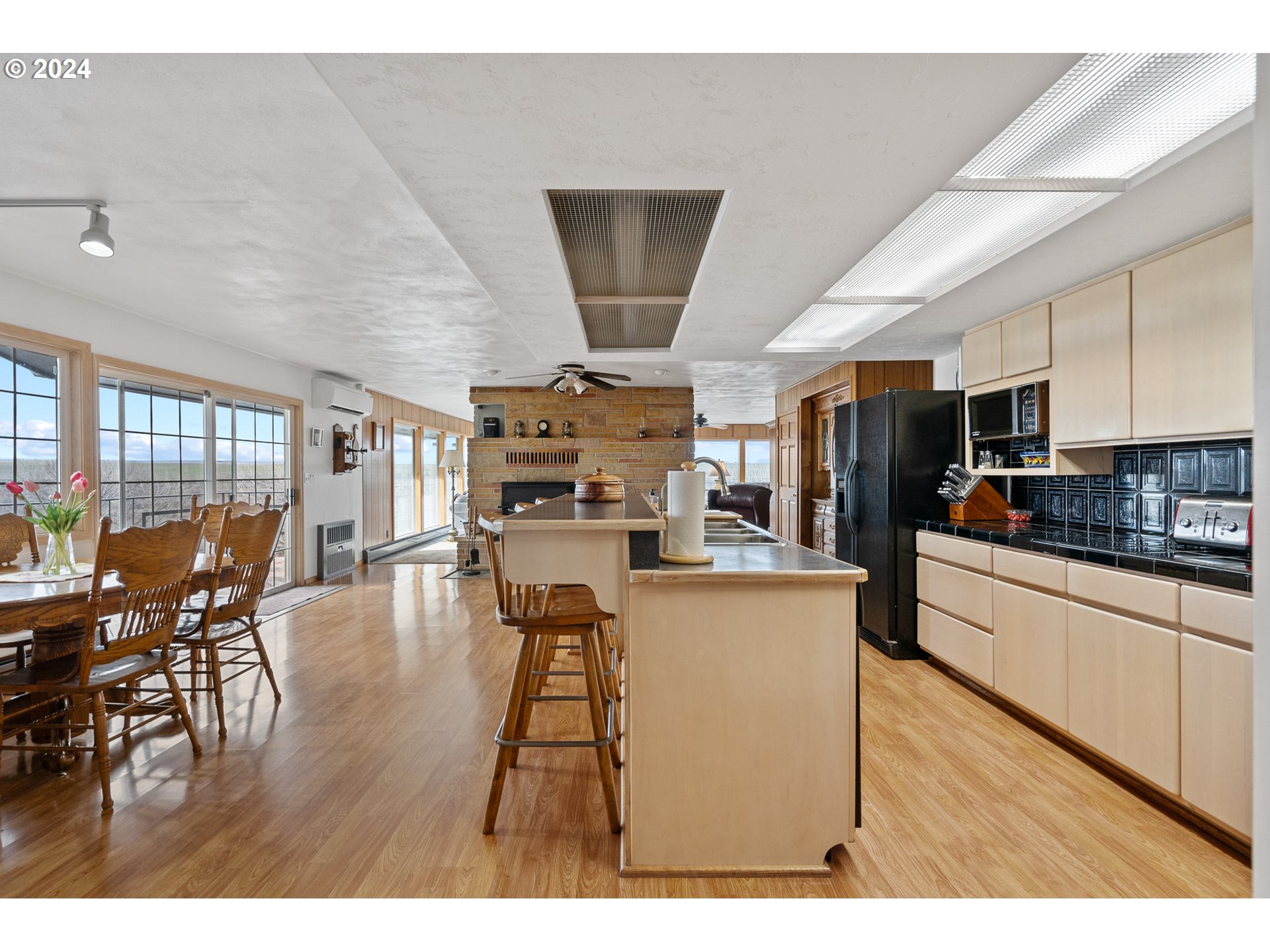 69748 Shaw Road Pendleton, OR 97801 - Photo 25 of 48 a kitchen with stainless steel appliances kitchen island granite countertop a table chairs and a refrigerator