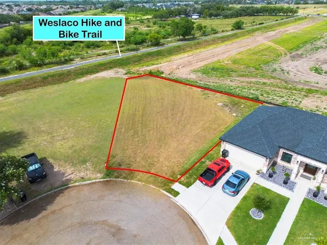 a view of a swimming pool with a yard and outdoor seating