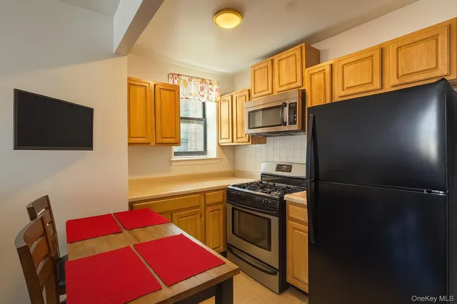 a kitchen with stainless steel appliances granite countertop a refrigerator stove top oven a sink and dishwasher