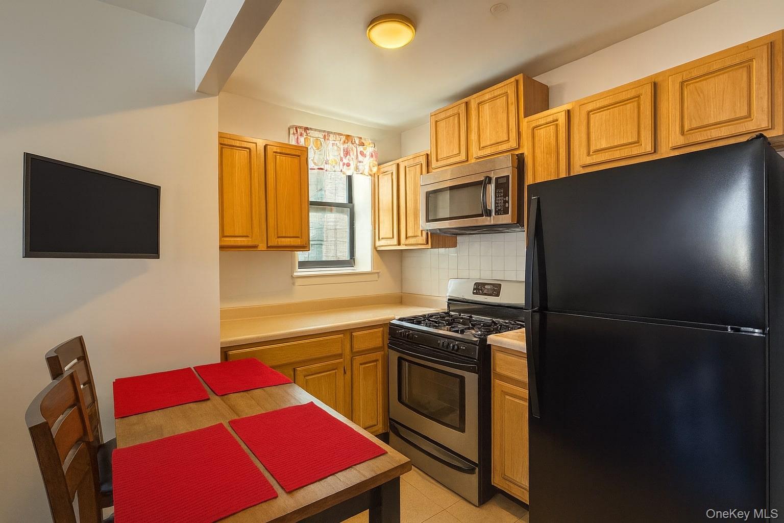 518 West 135th Street, Unit 5C Manhattan, NY 10031 - Photo 2 of 10 a kitchen with stainless steel appliances granite countertop a refrigerator stove top oven a sink and dishwasher
