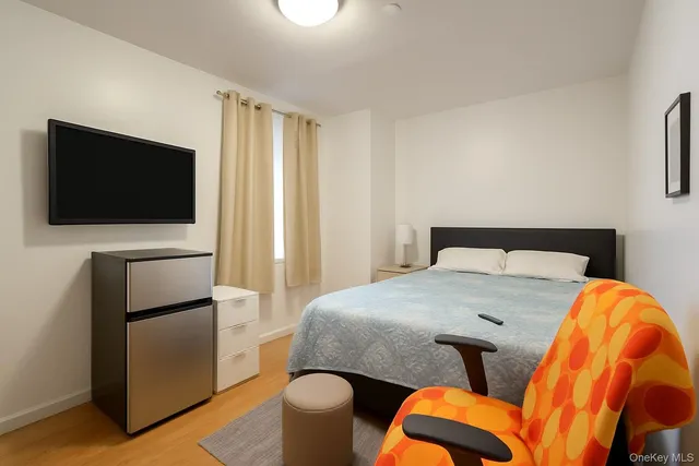 a bedroom with a bed and a television