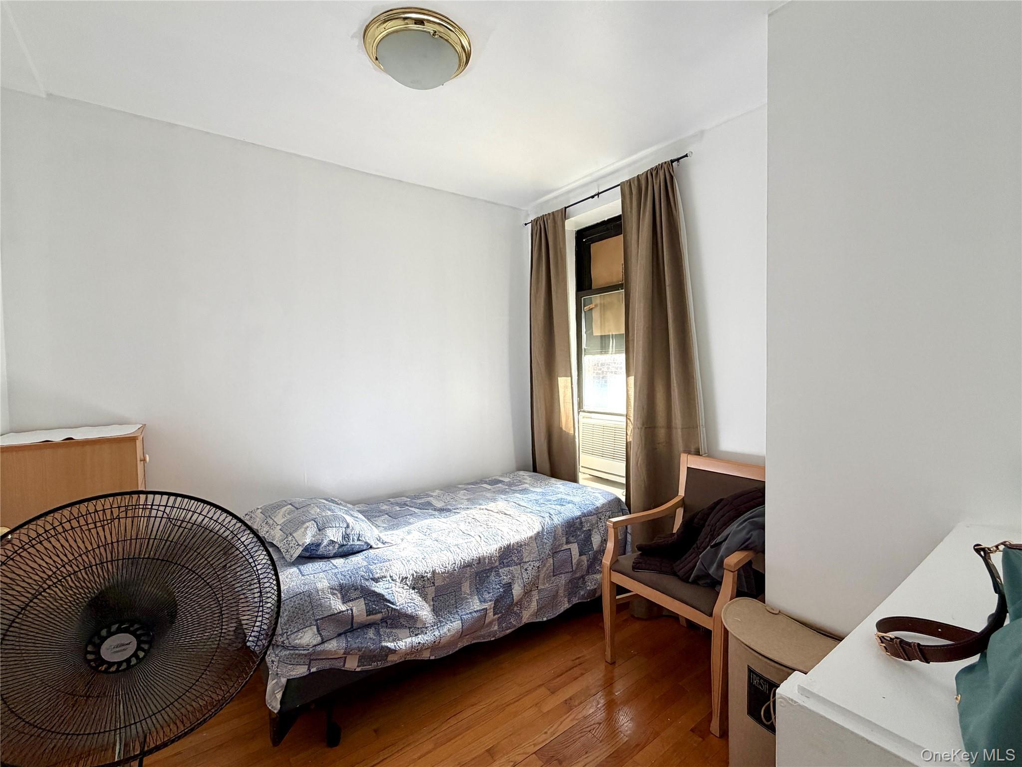 518 West 135th Street, Unit 5C Manhattan, NY 10031 - Photo 4 of 10 a bedroom with a bed and a window
