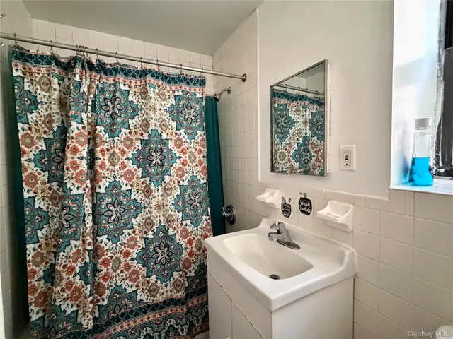 a bathroom with a sink and a shower curtain