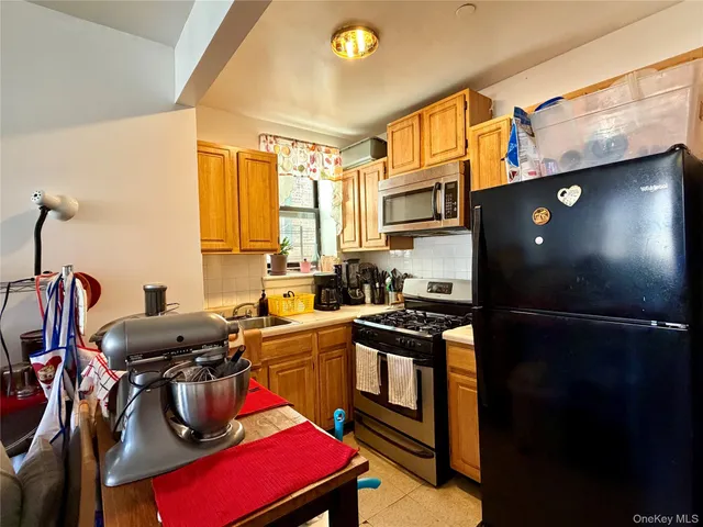 a kitchen with stainless steel appliances a sink stove and refrigerator