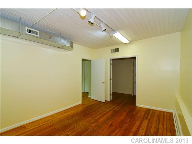 126 South Main Street, Unit 2B Davidson, NC 28036 - Photo 3 of 5 a view of an empty room with wooden floor