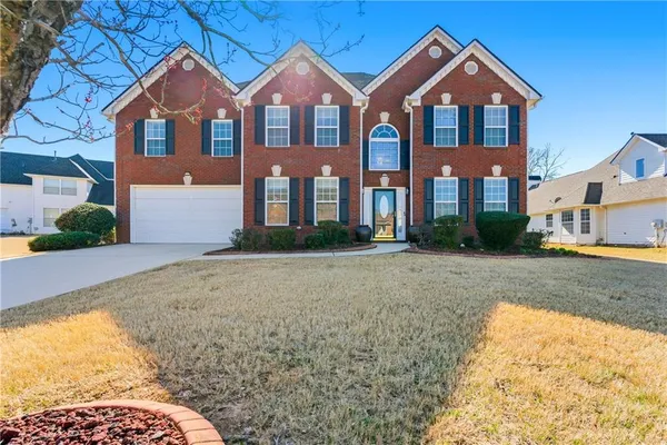 a front view of a house with a yard