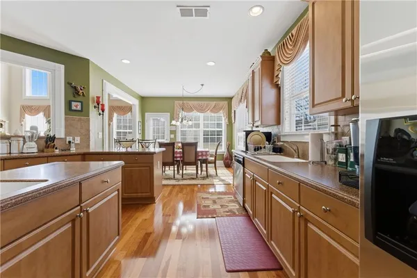 a kitchen with counter top space a sink and appliances