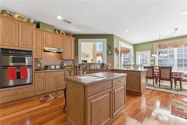 a kitchen with a sink stove and cabinets