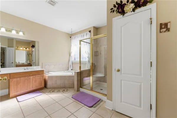 a spacious bathroom with a tub shower and sink