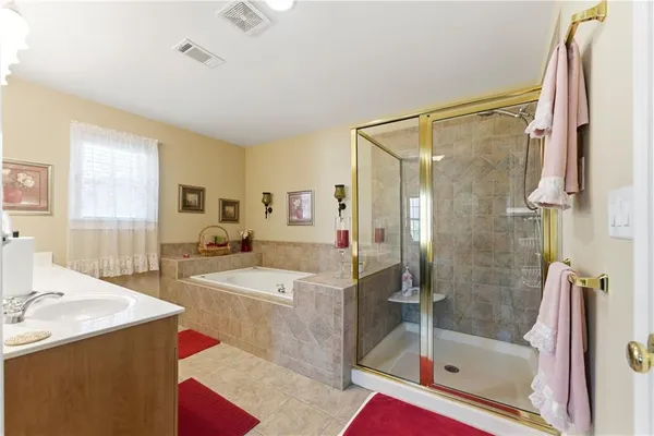 a spacious bathroom with sink shower and bathtub