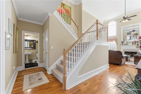 a view of entryway and hall with wooden floor