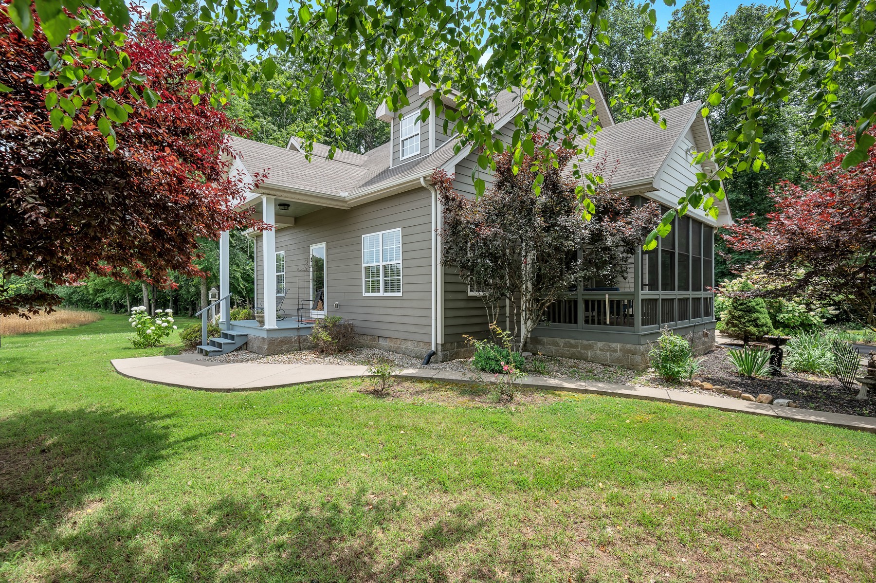 a view of a house with backyard and a tree