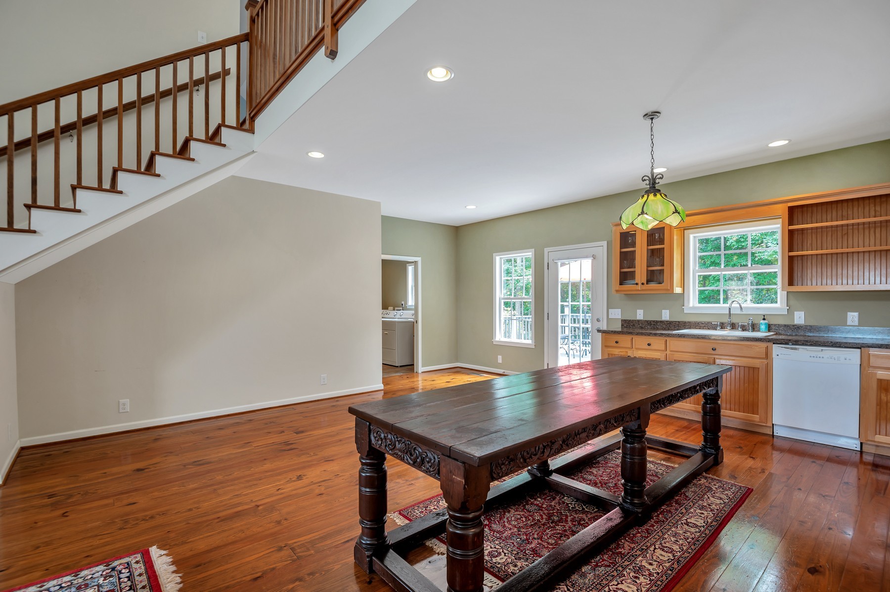4949 Homer Worsham Road Springfield, TN 37172 - Photo 18 of 33 an open kitchen with dining table chairs and wooden floor