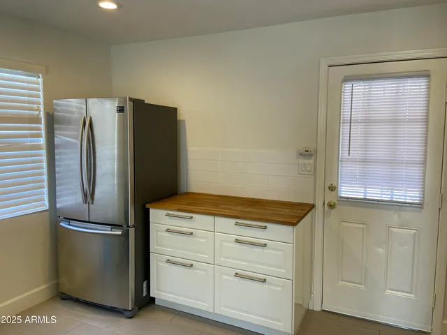 a kitchen with stainless steel appliances a refrigerator and cabinets