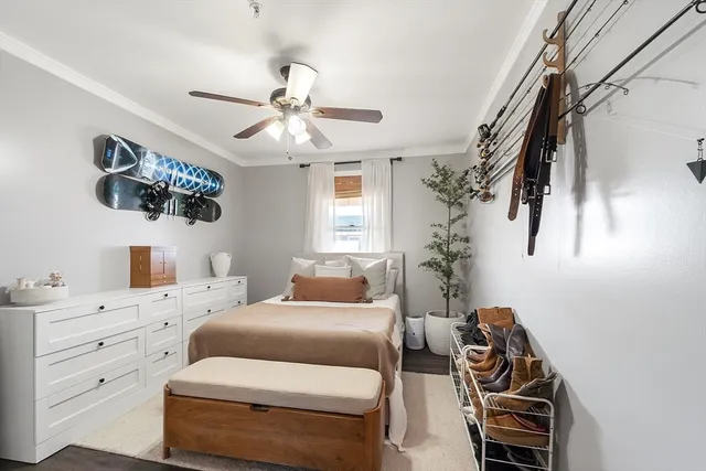 a bedroom with a bed and a chandelier