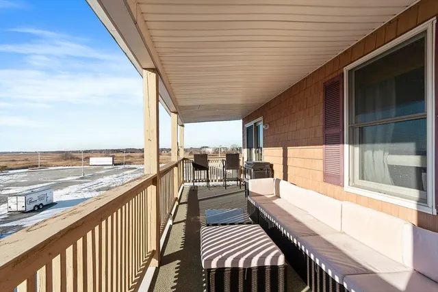 a view of a balcony with wooden floor