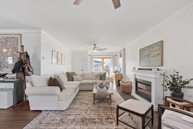 a living room with furniture fireplace and window