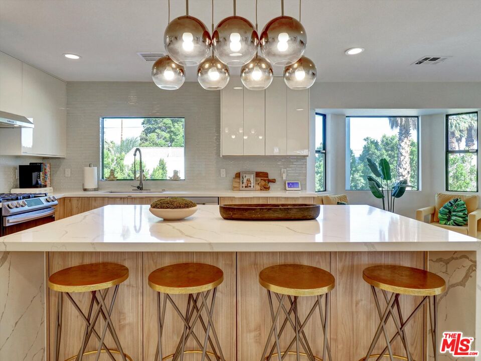 1920 North San Gorgonio Road Palm Springs, CA 92262 - Photo 4 of 23 a kitchen with a table chairs and a large window