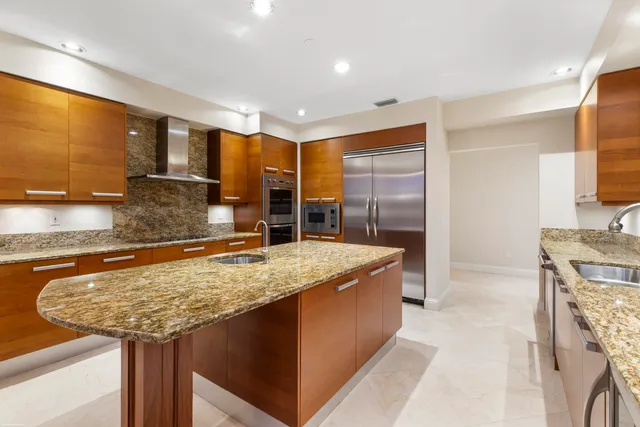 a view of a hallway with a chandelier fan and windows
