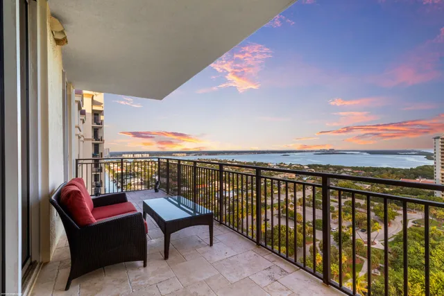 a view of a livingroom with a chandelier furniture and windows