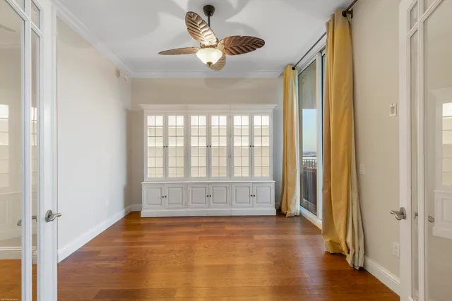 a view of walk in closet with wooden floor