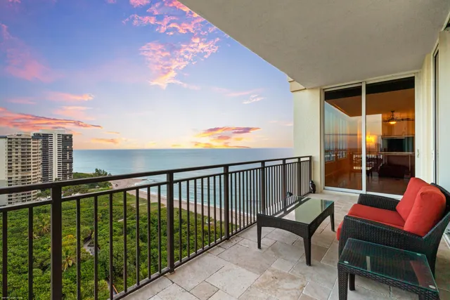 a view of a dining room with furniture and a chandelier