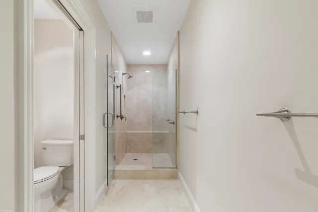 a view of a patio with a table and chairs under an umbrella