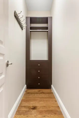 a sign that is sitting on a brick wall with a big yard