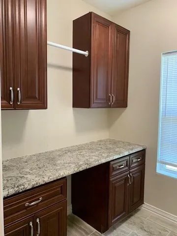 a kitchen with granite countertop wood cabinets and stainless steel appliances