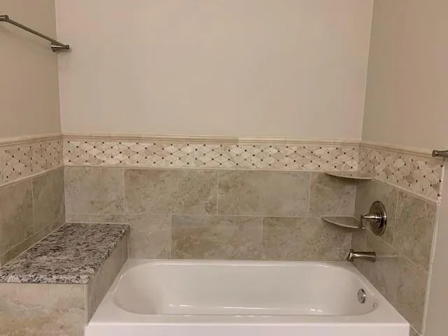 a bath tub sitting next to a white sink