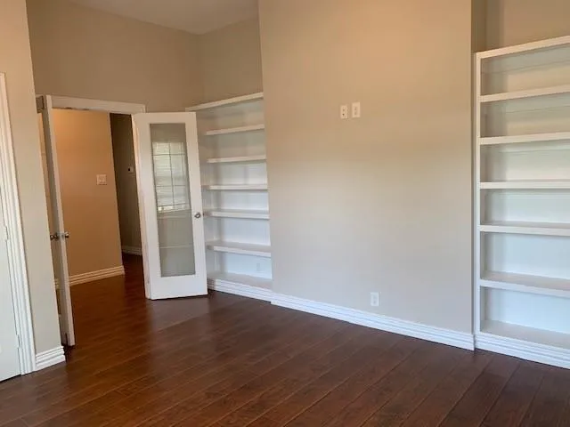 a view of a room with wooden floor