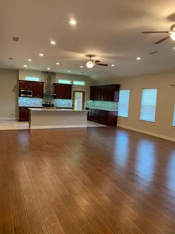 a view of kitchen with microwave and cabinets