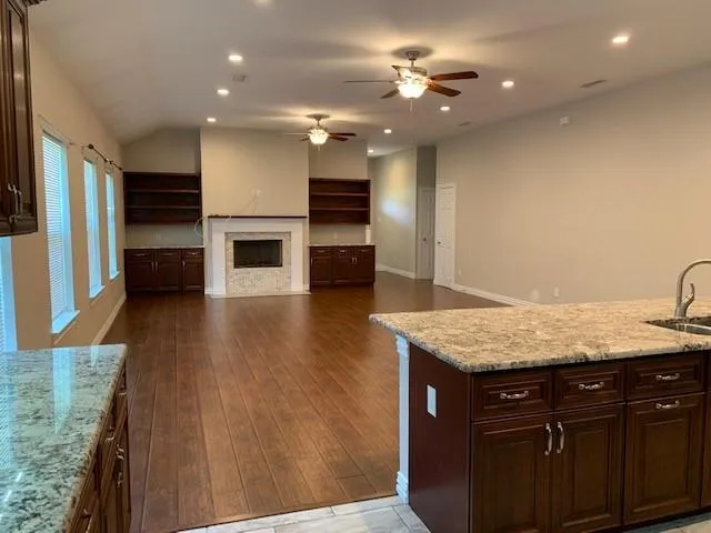 a kitchen with stainless steel appliances granite countertop a sink refrigerator and microwave