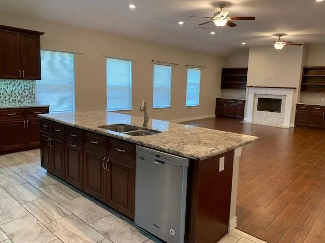 a kitchen with granite countertop cabinets a sink and a counter top space