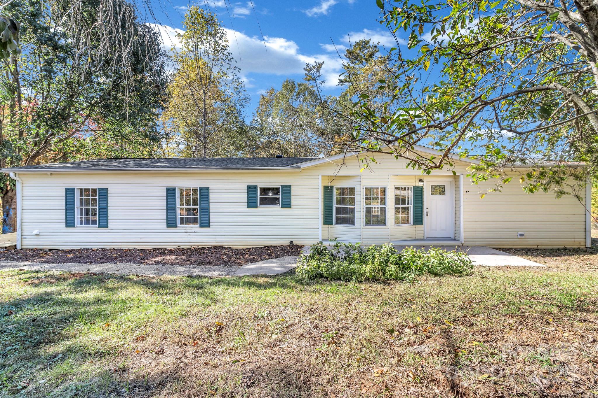80 Winter Lane, Unit 8&11 Mill Spring, NC 28756 - Photo 1 of 41 a front view of a house with garden