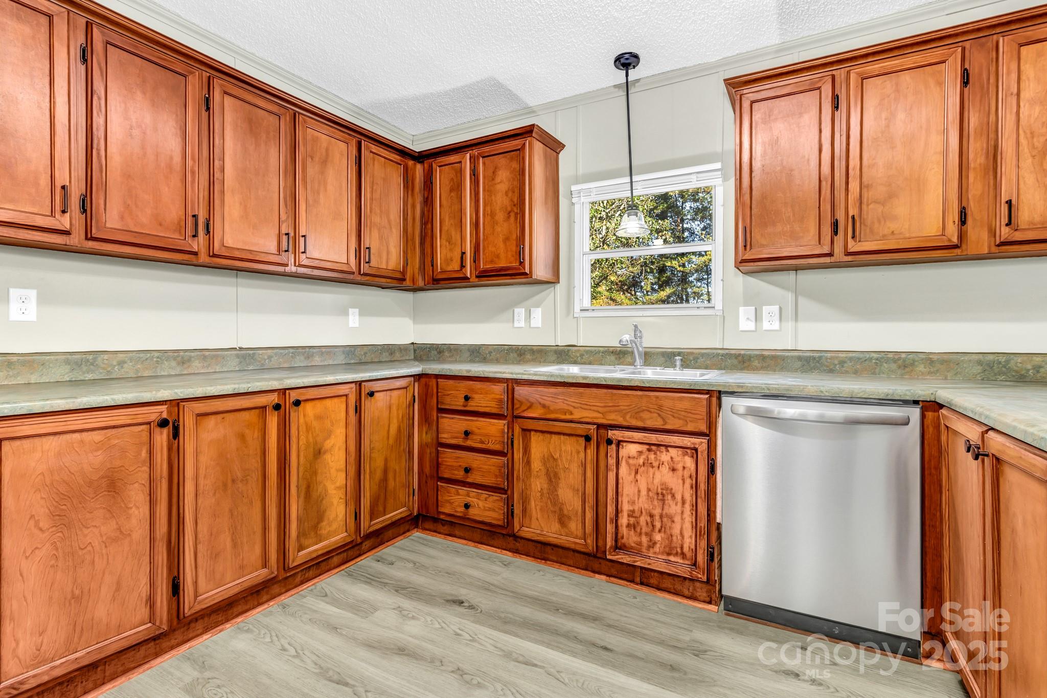 80 Winter Lane, Unit 8&11 Mill Spring, NC 28756 - Photo 16 of 41 a kitchen with stainless steel appliances granite countertop wooden cabinets a sink and a window