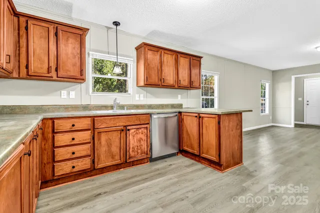 a kitchen with wooden cabinets and a sink