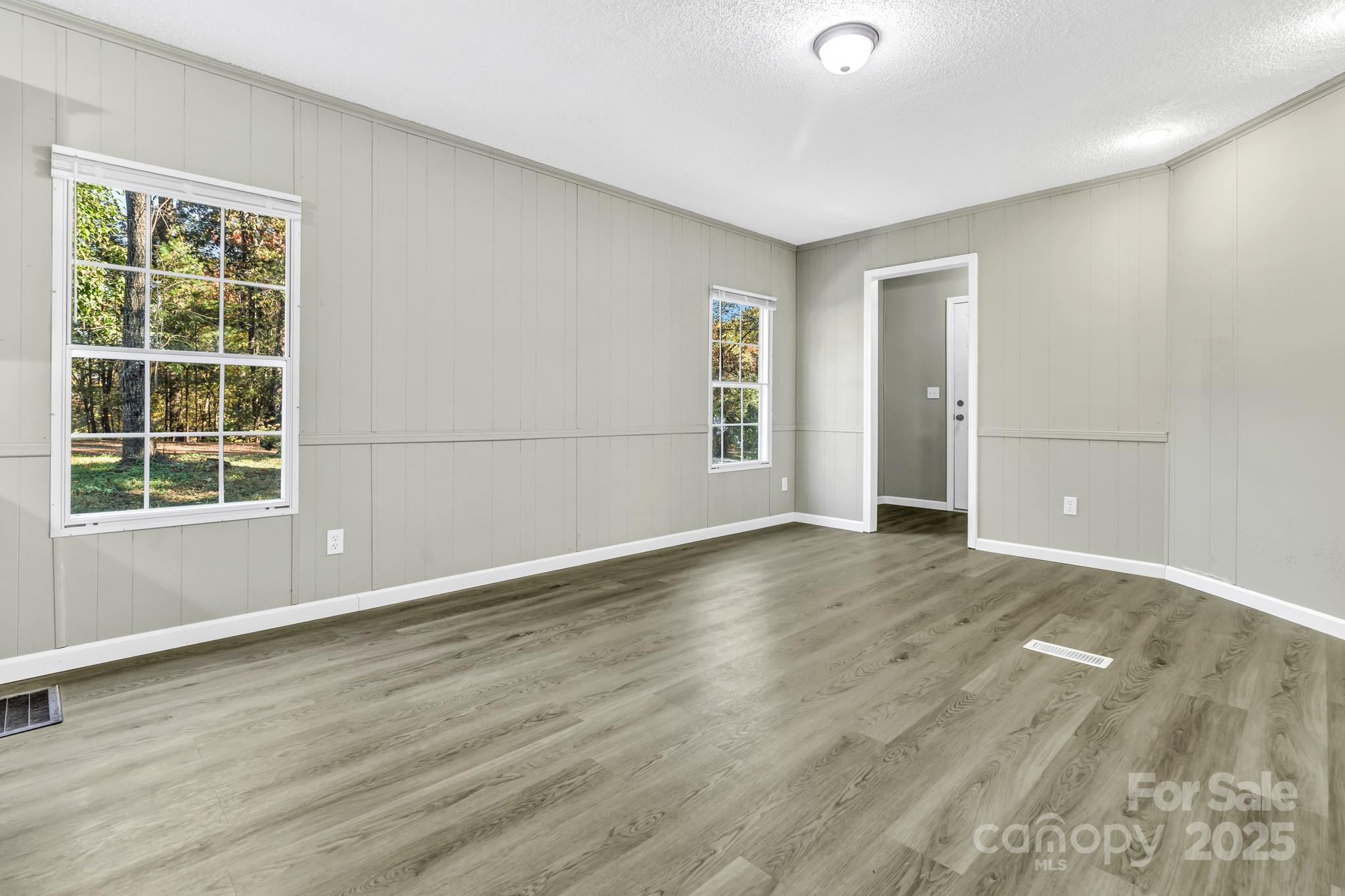 80 Winter Lane, Unit 8&11 Mill Spring, NC 28756 - Photo 25 of 41 a view of an empty room with wooden floor and a window