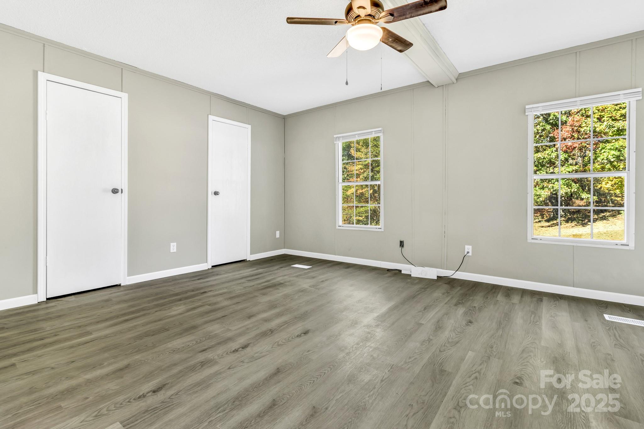 80 Winter Lane, Unit 8&11 Mill Spring, NC 28756 - Photo 27 of 41 a view of an empty room with a window and wooden floor