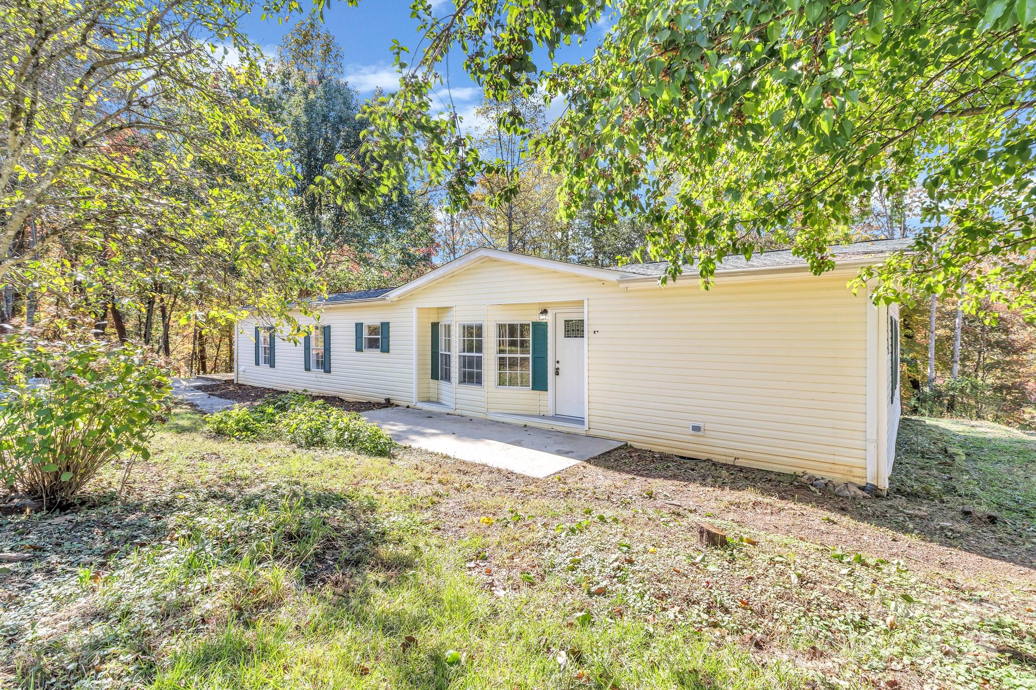 80 Winter Lane, Unit 8&11 Mill Spring, NC 28756 - Photo 3 of 41 a front view of a house with a garden